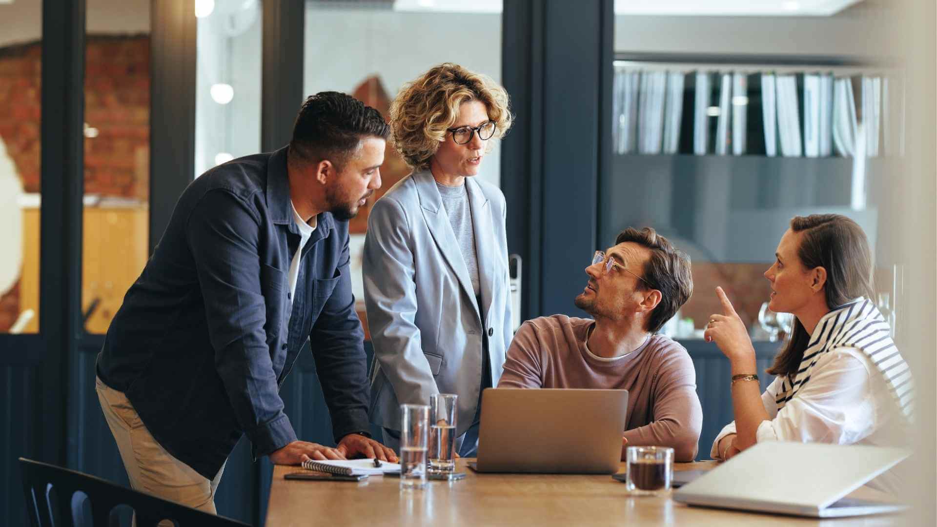 A marketing team discussing a campaign around a shared desk