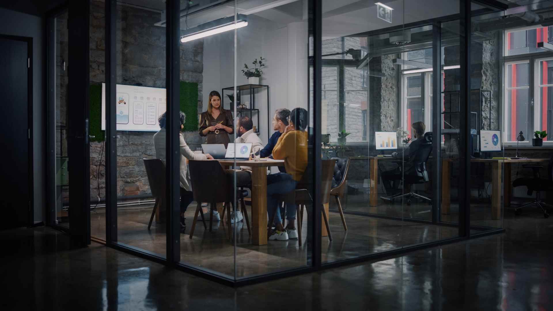 A performance report presentation in a glass-walled meeting room
